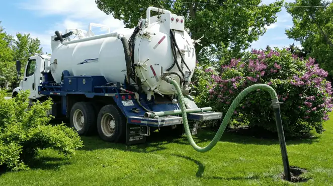 Professional vacuum truck performing residential drainage and septic maintenance in Pueblo, CO