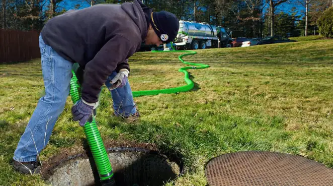 Service technician performing residential septic pumping and drainage maintenance in Pueblo, CO